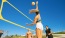 a person jumping to hit a volleyball